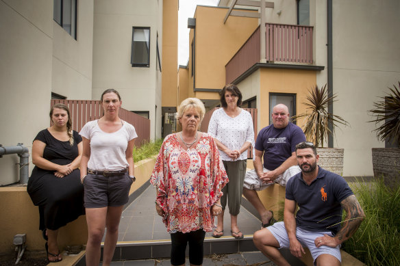 Frankston South apartment owner Kerry Ould (centre) in 2019 with her neighbours. Government-funded works to replace potentially dangerous cladding were finally been completed at her home last week.
