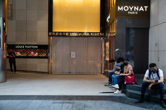 Shops in Hong Kong's once-vibrant commercial districts are now shuttered to prevent damage. 