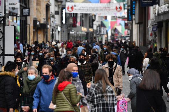 Shoppers wear protective face masks on a crowded street in Brussels, Belgium, on Friday, October 16. Belgium trails only the Czech Republic for new cases per capita in Europe. 