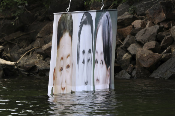 A banner attached to a balloon with images of North Korean leader Kim Jong-un, the late leader Kim Il-sung, and Kim Yo-jong, released by Fighters For Free North Korea in Hongcheon, South Korea, in 2020. The North has repeatedly warned it would retaliate against leaflets and other information being distributed over the border. 