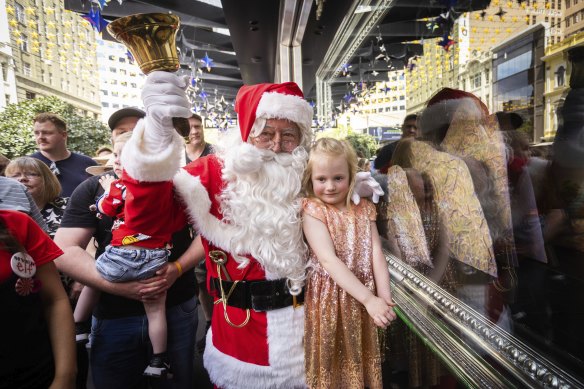 It’s that time of year: Santa Claus with Grace, 5, at the Myer Christmas windows in Bourke Street Mall.