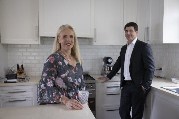 Kai and Neale Jones, pictured in their current home, are among the buyers who have chosen a car space with electric vehicle charging for their new unit.