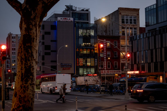 A glass building, centre, on East Broadway in New York’s Chinatown, where a Chinese outpost is suspected of conducting police operations without jurisdiction or diplomatic approval.