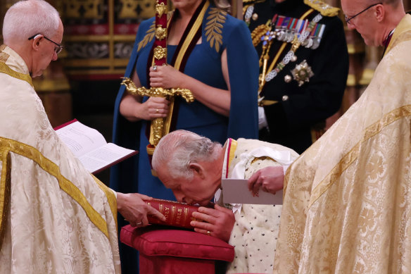 Charles kisses the Bible before being crowned King. 