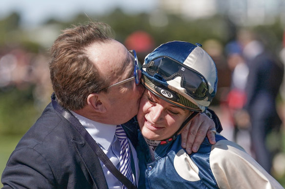 Part-owner John O’Neill plants a kiss on winning jockey Jamie Kah.