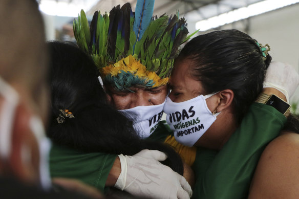 Relatives cry during the funeral of Kokama Chief Messias Martins Moreira, who died of COVID-19, during his burial service at the Park of Indigenous Nations in Manaus, Brazil. 