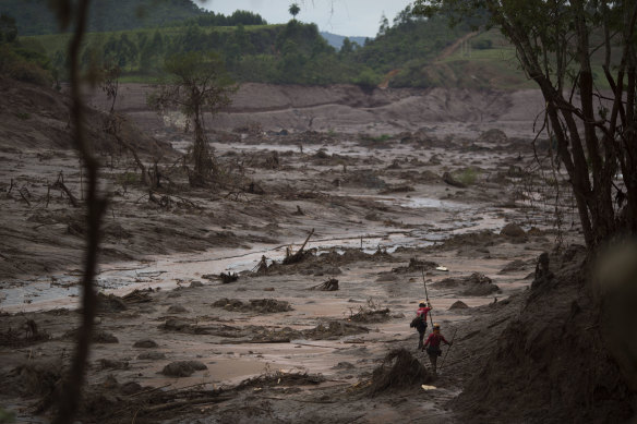 Rescue workers search for victims at the site where the town of Bento Rodrigues stood three days after the Samarco dam burst in 2015.