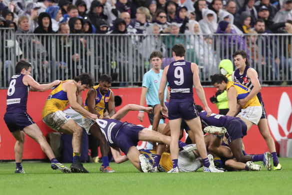 Both teams are involved in a melee during the round 22 derby match between the Fremantle Dockers and the West Coast Eagles at Optus Stadium on Saturday night.