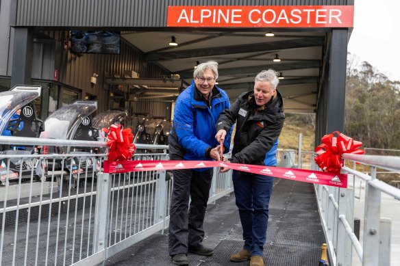 EVT chairman Alan Rydge (left) and Thredbo general manager Stuart Diver cut the ribbon at the Alpine Coaster launch event.