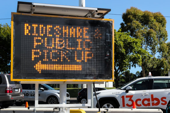 A sign outside Melbourne Park on Monday indicating where tennis fans can take a ride-share vehicle.