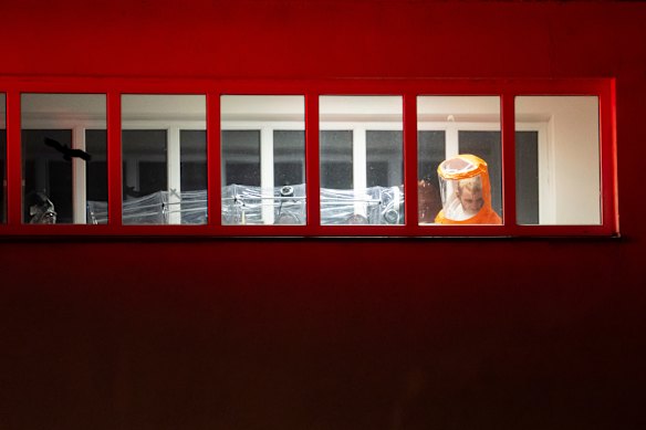 A US citizen, who was in contact with a person who contracted the Ebola virus (left) arrives at the Bulovka University Hospital in Prague, Czech Republic, on Thursday, May 21. 