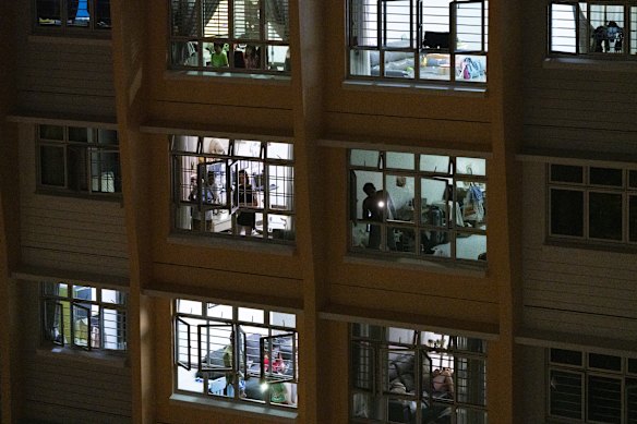 Singaporeans gather at their window to sing and shine their phones in tribute to healthcare workers and migrant workers during the lockdown.