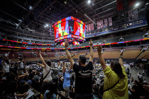 Vaccine recipients at Scotiabank Arena, Toronto, cheer for giveaways as the number of doses administered reaches 25,000. The venue went on to set a North American record of 26,771 jabs in a day. 