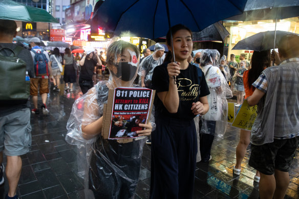 A demonstrator holds a sign during the peaceful protest on Sunday in Hong Kong. 