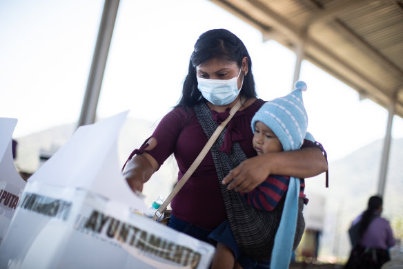 A woman casts her vote at a polling station in Alcozacan, Mexico, on Sunday.