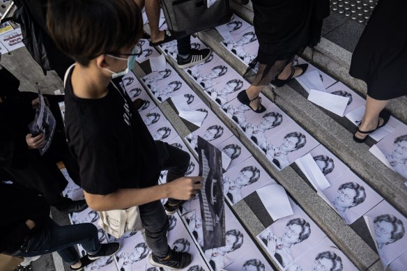 Students step on posters featuring Hong Kong Chief Executive Carrie Lam during a protest ahead of a graduation ceremony at the Chinese University of Hong Kong (CUHK) on Thursday.