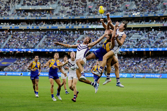 Fremantle’s Brennan Cox spoils a mark during the western derby in round 3 this year.