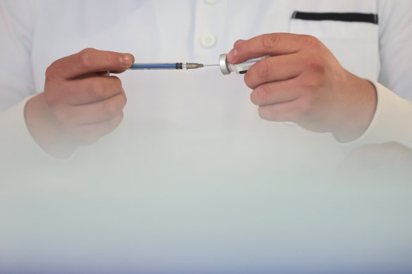 A nurse prepares a syringe with doses of the COVID-19 AstraZeneca vaccine.