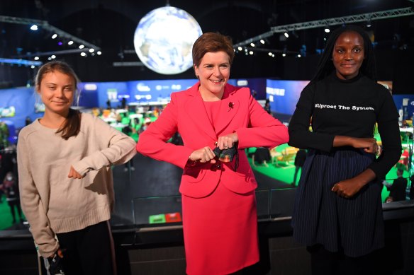 Greta Thunberg poses with Scotland’s First Minister Nicola Sturgeon (C) and fellow climate activist Vanessa Nakate (R) on Monday, November 1 at the COP26 conference in Glasgow. 