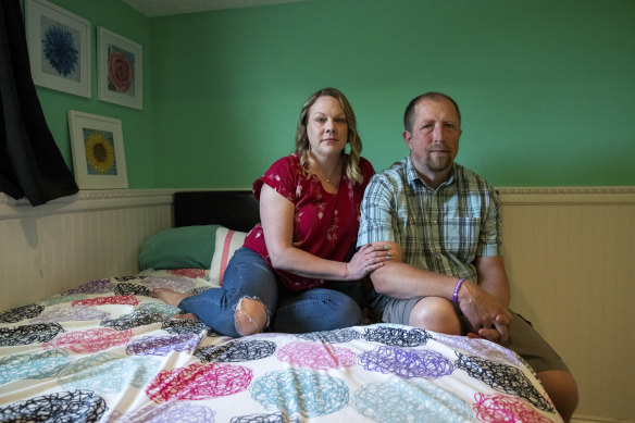 Ashley and Chris Bracken sit on  their daughter’s bed.