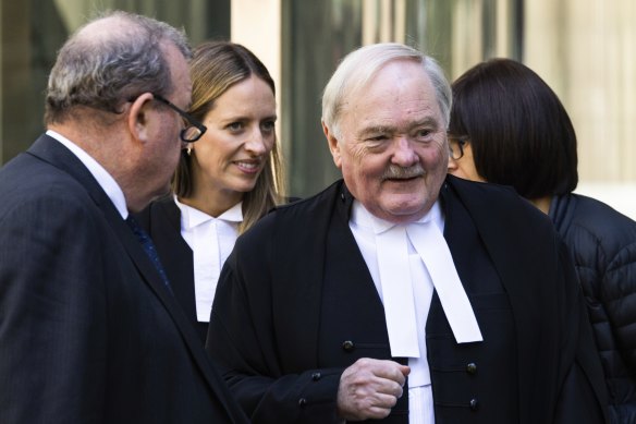 Ian Hill, KC (front right), outside the County Court in March.