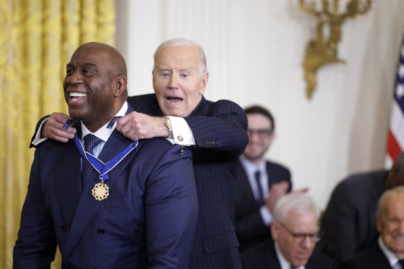 US President Joe Biden awards former NBA player Earvin “Magic” Johnson the Presidential Medal of Freedom in the East Room of the White House.