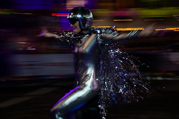 A human disco ball flies through the crowd.