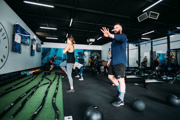 Reece Tuohey [right] instructing clients at his Bendigo gym.
