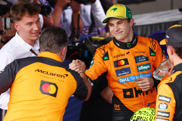 McLaren chief Zak Brown congratulates Piastri on his front-row race start.