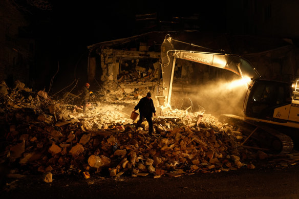 Rescuers search for people in destroyed buildings in Elbistan, southern Turkey.