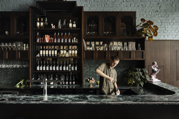 A green marble bar dominates the ground floor entry area.