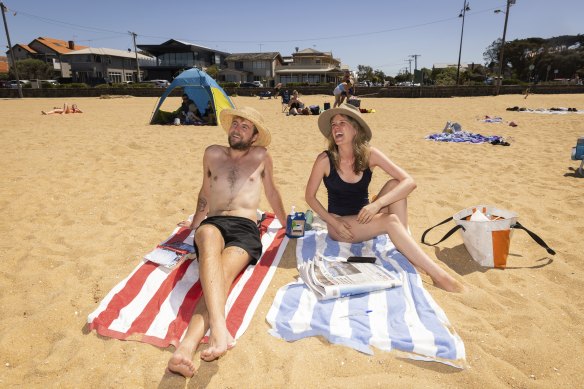 Tom Wharton and Eve Giles enjoying the sun at Williamstown Beach after 7 days of isolation.