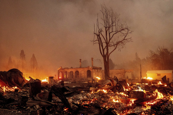 Buildings burn as the Dixie Fire tears through the Greenville community of Plumas County, California, on Wednesday, August 4.