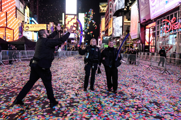 Members of the New York City Police Department (NYPD) celebrate New Year’s Eve in Times Square. Viewing areas that normally accommodate about 58,000 people were limited to about 15,000 to allow for social distancing.