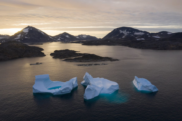 Large Icebergs float away as the sun rises near Kulusuk, Greenland. Scientists are hard at work, trying to understand the alarmingly rapid melting of the ice. 