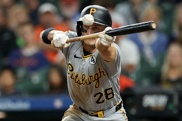 Jake Mangum #28 of the Pittsburgh Pirates bunts for a single in the sixth inning against the Houston Astros at Daikin Park in Houston, Texas.