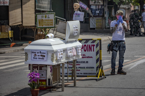 A coffin is part of a street display warning residents of Santo Tomas, Philippines, to stay home during the coronavirus outbreak.