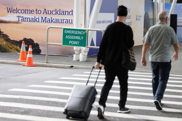 Travelers at Auckland International Airport.