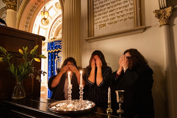 Janice Furstenberg (left), Rebbetzin Rachel Gutnick and Jenny Segal at the East Melbourne Synagogue, lighting candles to bring in Shabbat.
