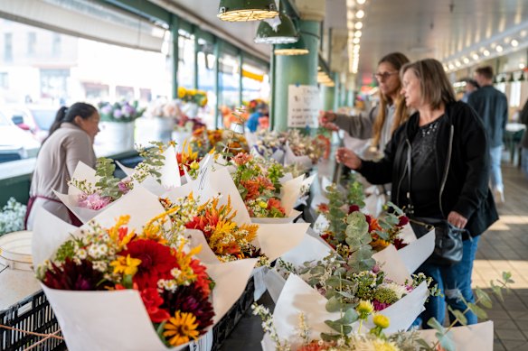 Stalls sell fresh flowers at Pike Place Market.