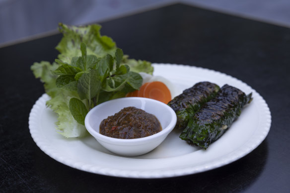 Garlicky pork belly and
shoulder sausages ($18) wrapped in betel leaves and charred pineapple sauce.