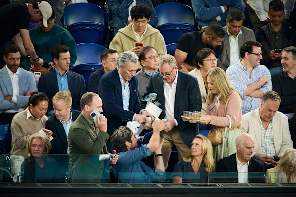 Former BHP chairman Ken Mackenzie (green blazer front row), Tabcorp CEO Gillon McLachlan, Laura McLachlan, and Transurban chairman Craig Drummond. (Second row) BHP CEO Mike Henry (left), Barrenjoey chairman Matthew Grounds, and REA CEO Cameron McIntyre at the Australian Open Men’s final.