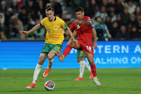 Jackson Irvine wrestles for the ball