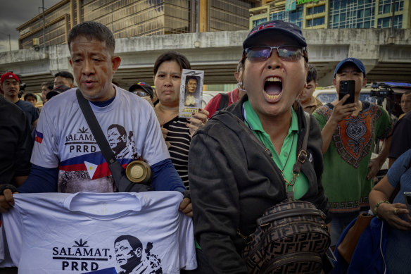Supporters of former president Rodrigo Duterte gather outside Villamor Airbase, where Duterte was taken following his arrest on an ICC warrant.