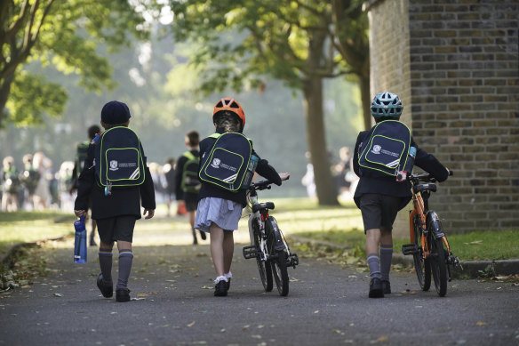 Pupils from Corpus Christi Catholic School, Brixton, arrive at St Martin’s in the Field Girls’ School in London, as they are relocated after their school was found to be affected.