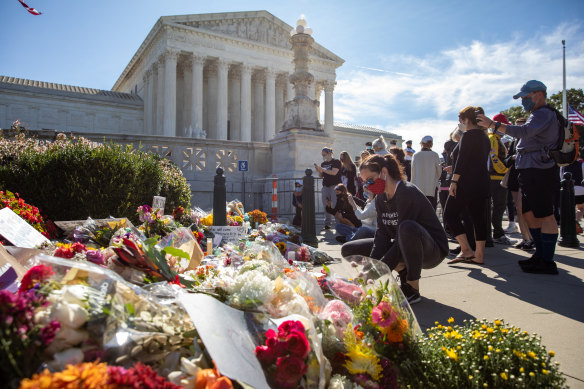 Mourners gather at a makeshift memorial during a vigil for  Ruth Bader Ginsburg outside the Supreme Court in Washington, D.C., on Saturday.