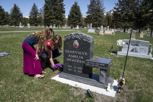 Ashley Bracken and one of her other daughters, Juliet, visit the grave of Genevieve, who died by suicide at the age of 14.