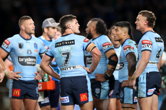 The Blues gather under the posts after conceding a try.