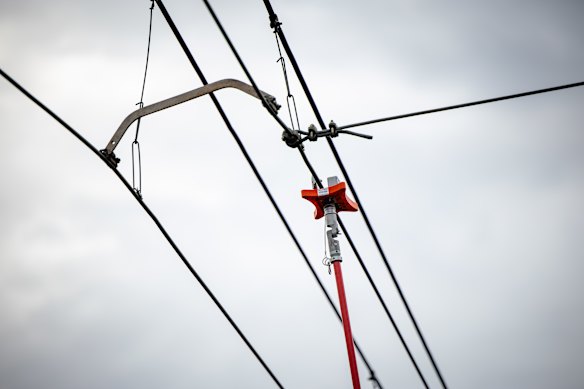 Workers demonstrate a new of hand-held laser device to check over-head wiring and prevent another Sydney train meltdown