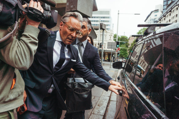 Surgeon William Mooney exits a NSW Civil and Administrative Tribunal hearing.